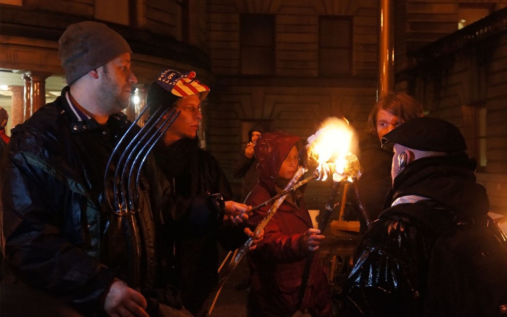 Sponberg (l) Leads City Hall Protest with Pitchfork, Torches. (via Al-Jazeera America)